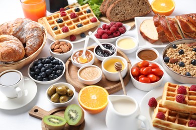 Photo of Different meals served for breakfast on white table