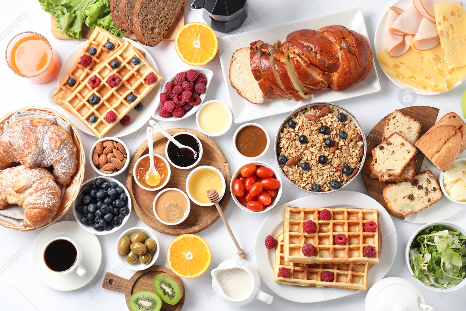 Photo of Different meals served for breakfast on white table, flat lay