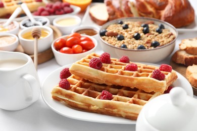 Photo of Different meals served for breakfast on white table, closeup. Buffet menu