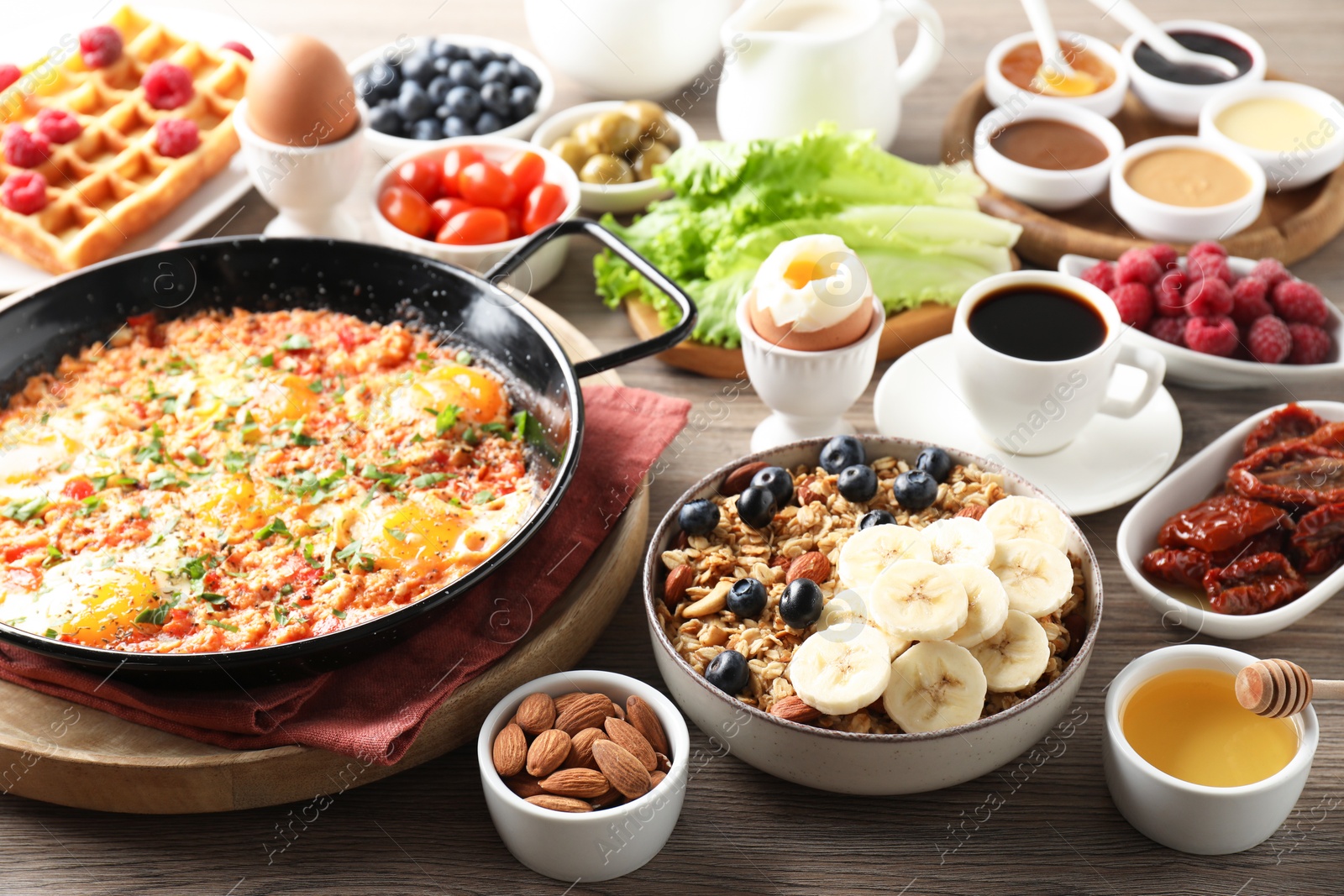 Photo of Different meals served for breakfast on wooden table