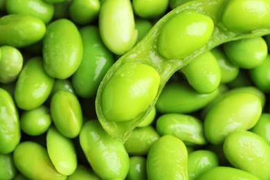 Photo of Fresh edamame pod and soybeans as background, top view