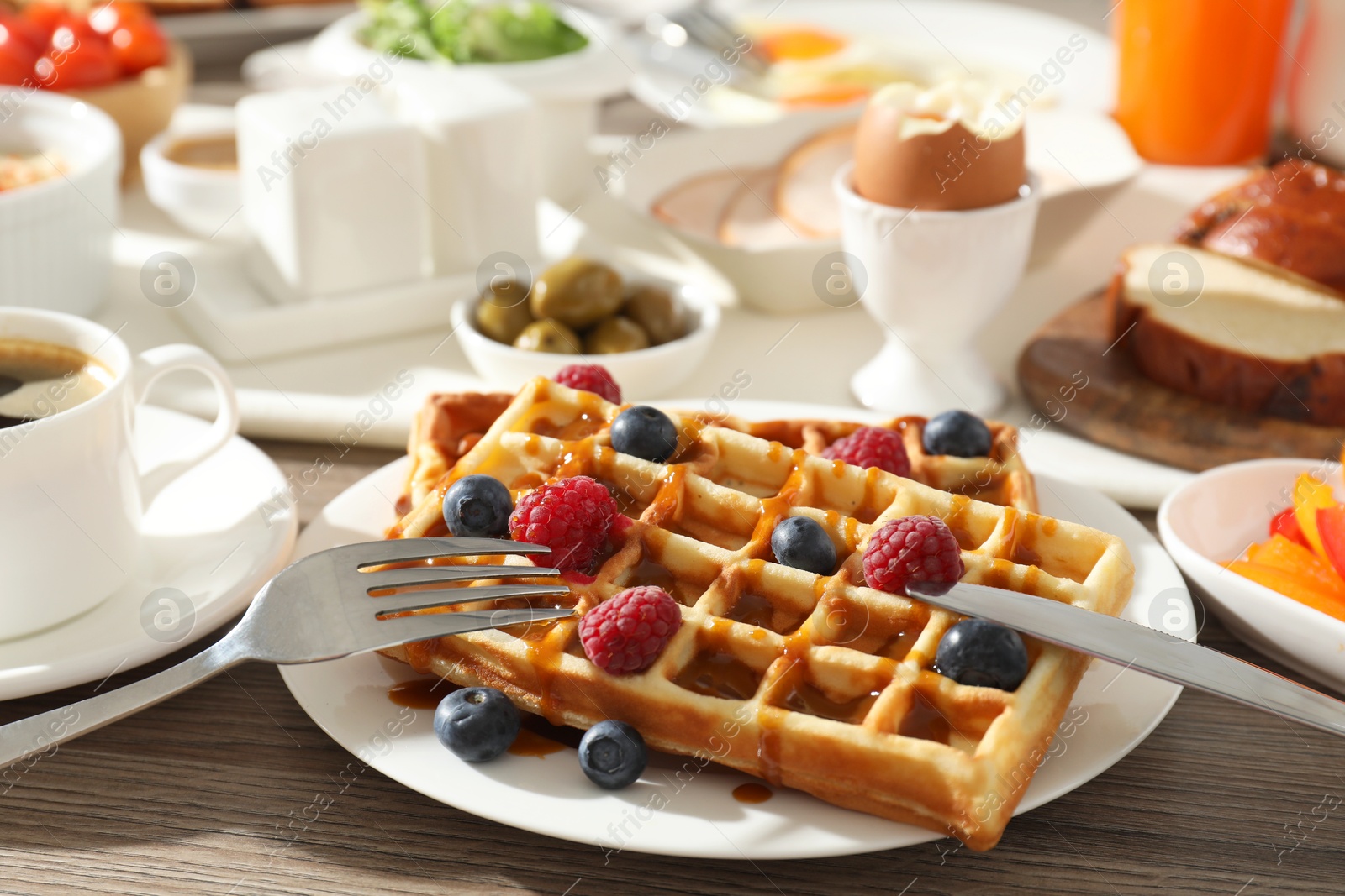 Photo of Different meals served for breakfast on wooden table