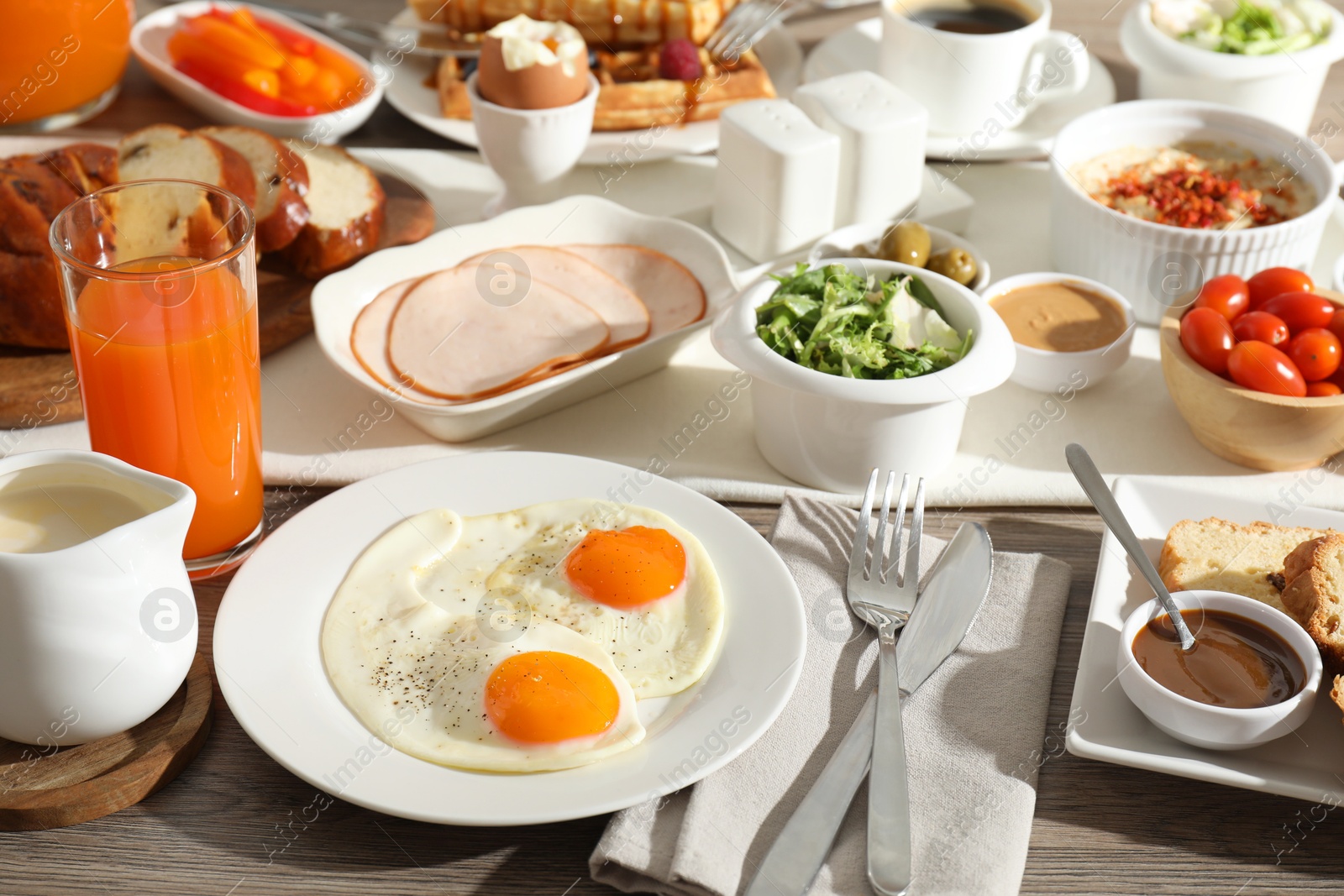 Photo of Different meals served for breakfast on wooden table