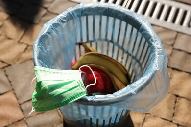 Trash bag with garbage in bin outdoors, closeup