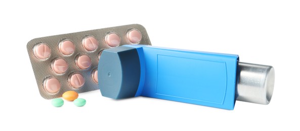 Photo of Asthma treatment. Inhaler and pills isolated on white