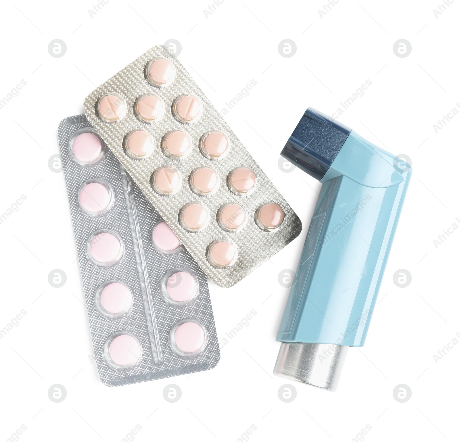 Photo of Asthma treatment. Inhaler and pills isolated on white, top view