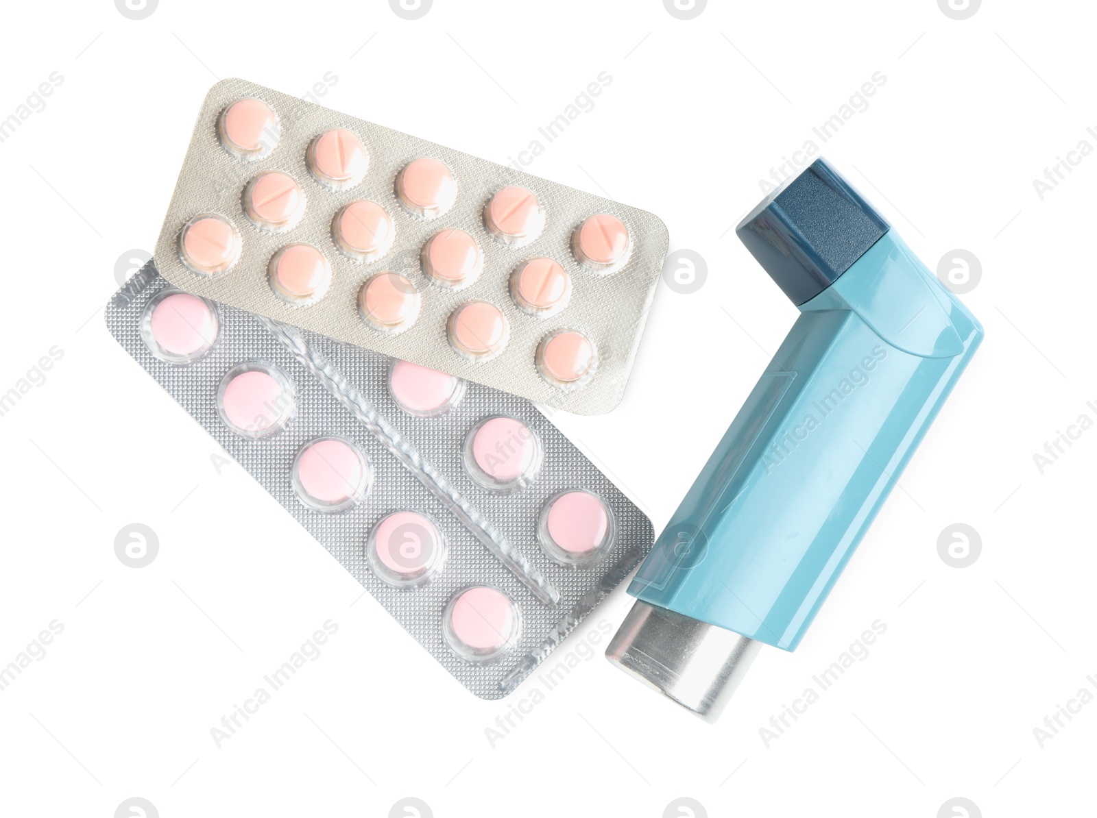 Photo of Asthma treatment. Inhaler and pills isolated on white, top view