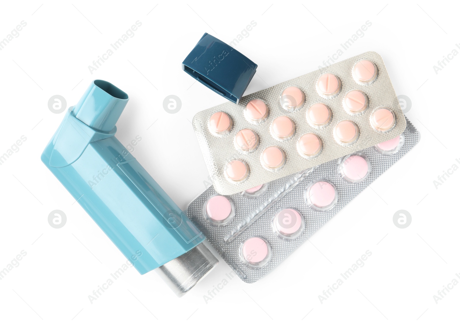 Photo of Asthma treatment. Inhaler and pills isolated on white, top view