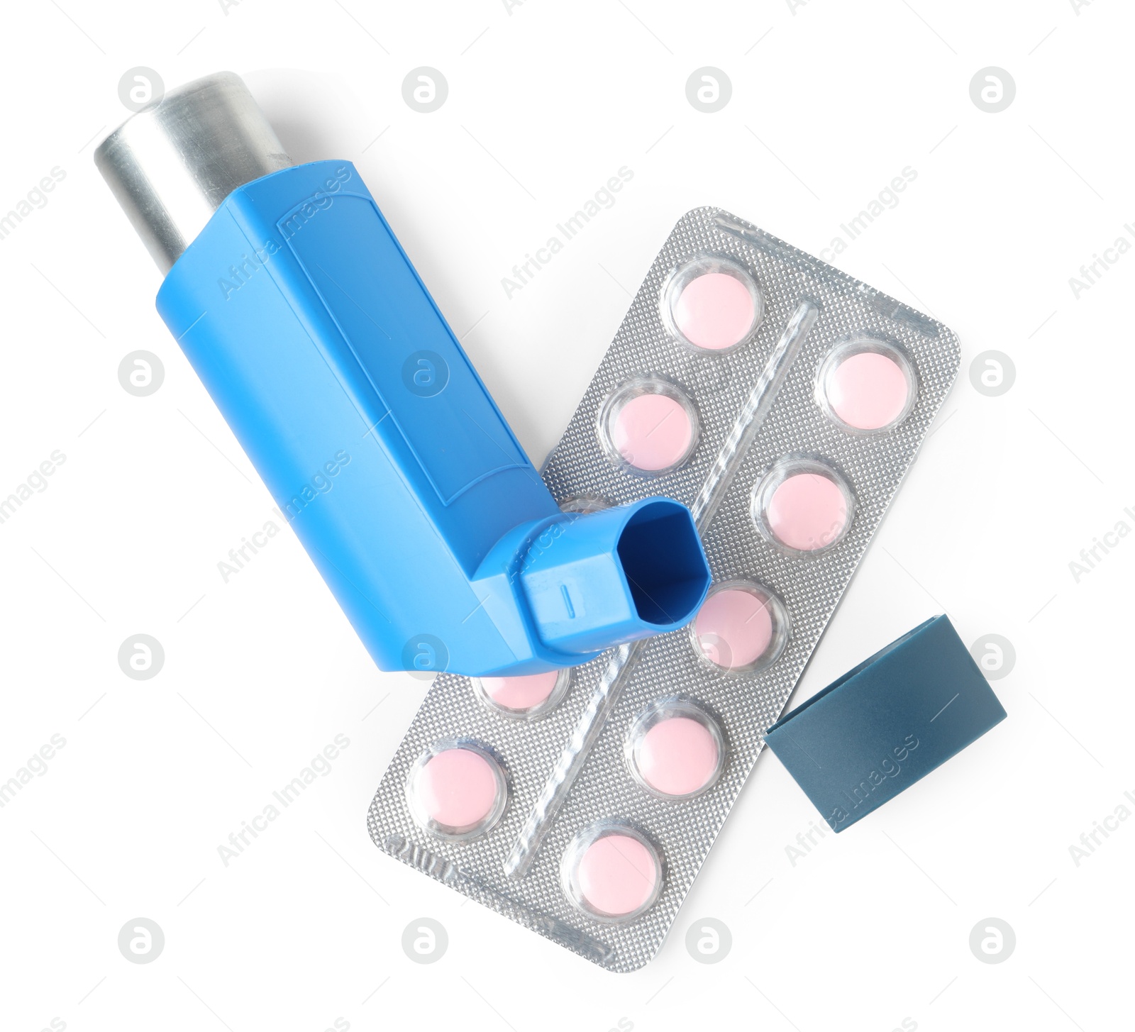 Photo of Asthma treatment. Inhaler and pills isolated on white, top view