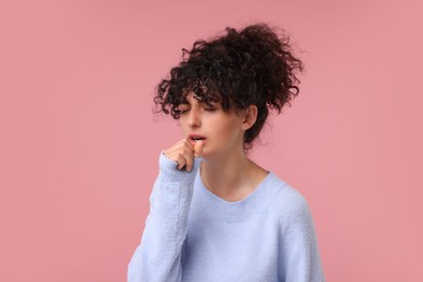 Photo of Cold symptom. Young woman suffering from illness on pink background