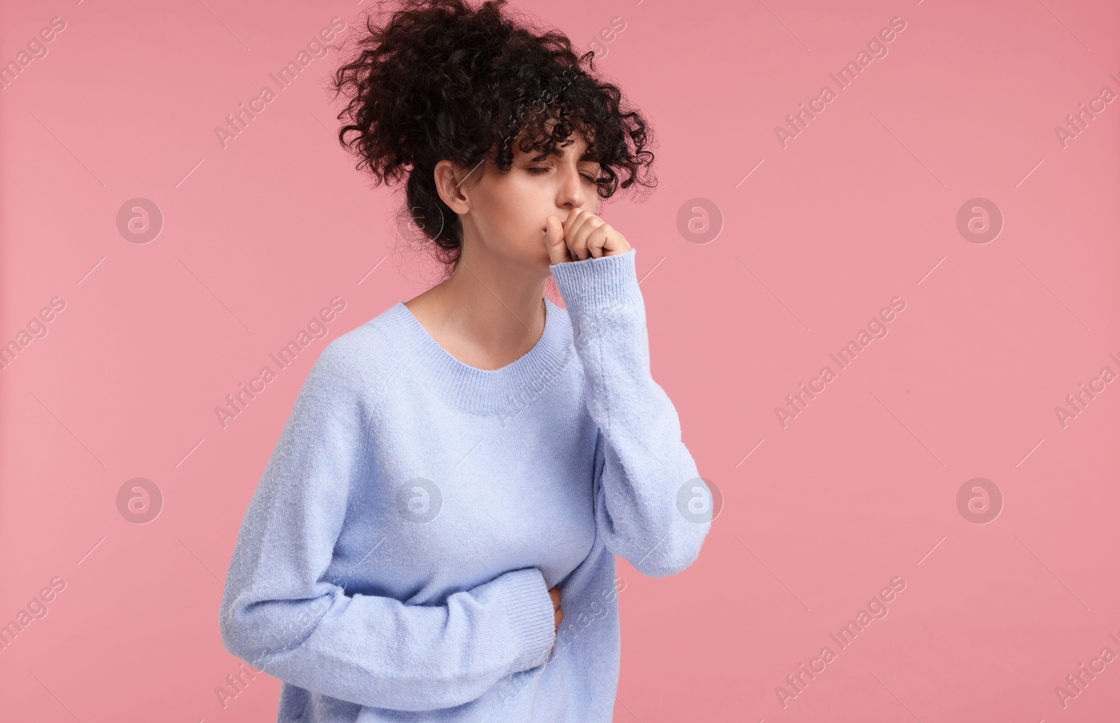 Photo of Cold symptom. Young woman suffering from illness on pink background, space for text