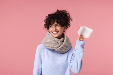 Photo of Cold symptom. Happy young woman with tissue on pink background