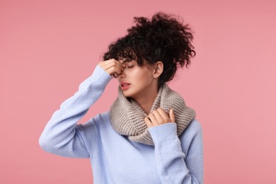 Photo of Cold symptom. Young woman suffering from illness on pink background