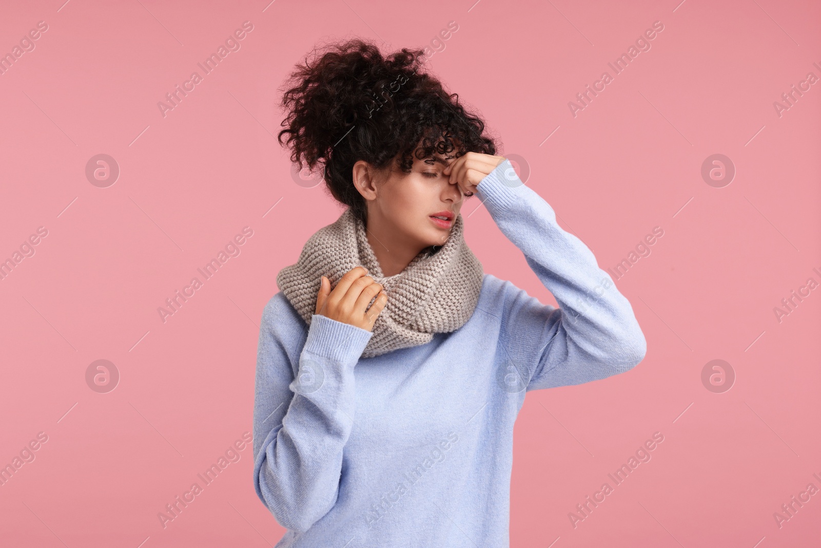 Photo of Cold symptom. Young woman suffering from illness on pink background