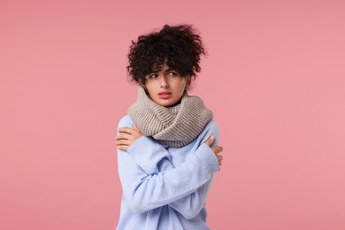 Cold symptom. Young woman suffering from illness on pink background