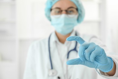 Doctor holding something in clinic, selective focus. Space for text