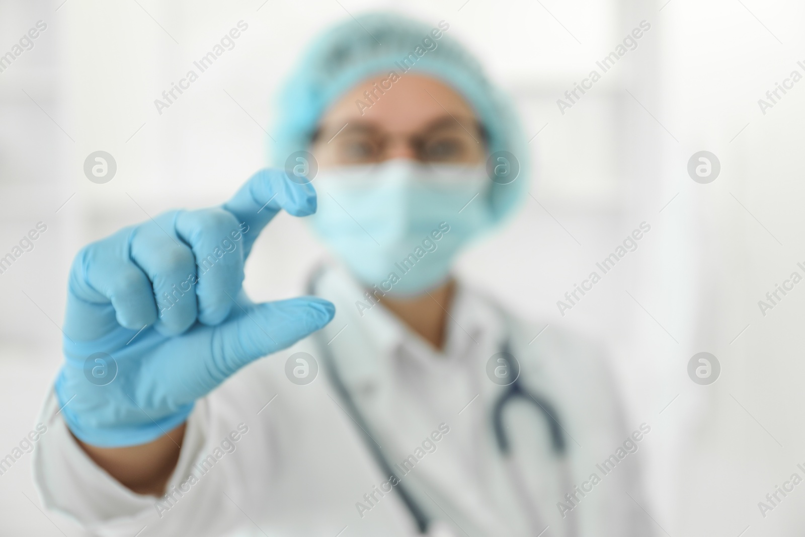 Photo of Doctor holding something in clinic, selective focus. Space for text