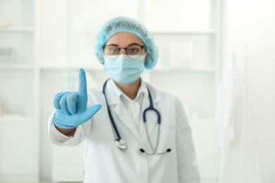 Doctor pointing at something in clinic, selective focus