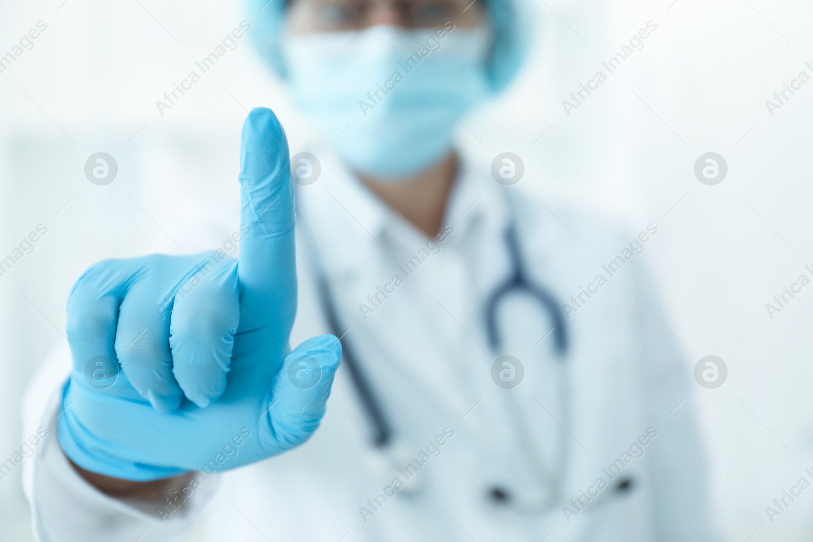 Photo of Doctor pointing at something in clinic, closeup view. Space for text