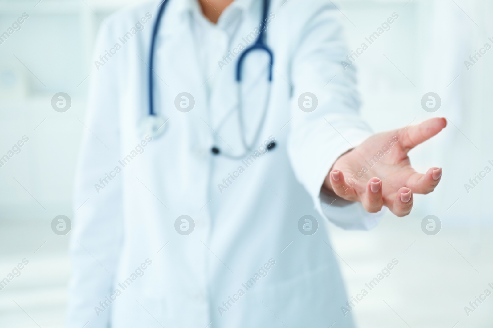 Photo of Doctor holding something in clinic, closeup view. Space for text