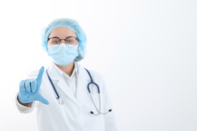 Photo of Doctor holding something on white background, selective focus