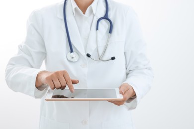 Photo of Doctor with tablet on white background, closeup view