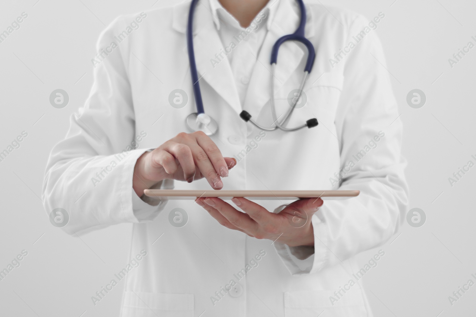 Photo of Doctor with tablet on white background, closeup view