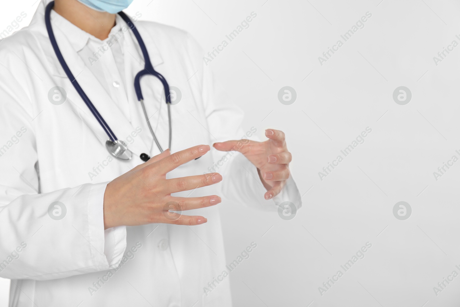 Photo of Doctor holding something on white background, closeup. Space for text