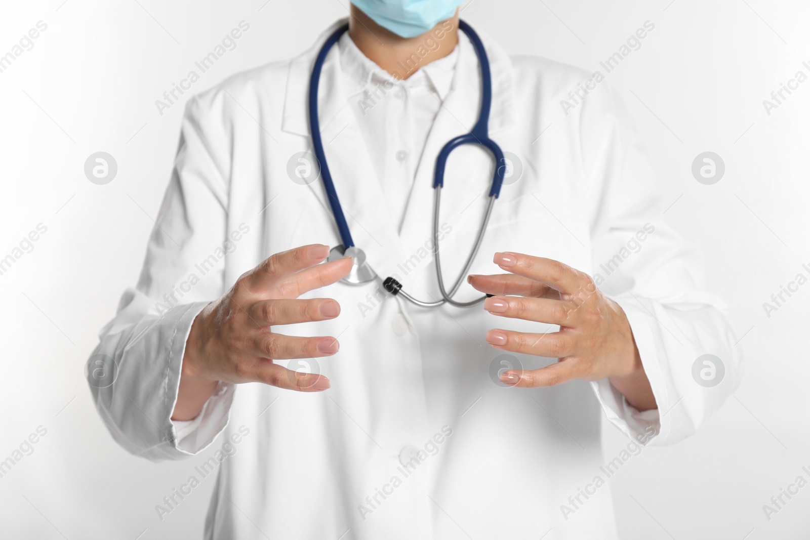 Photo of Doctor holding something on white background, closeup