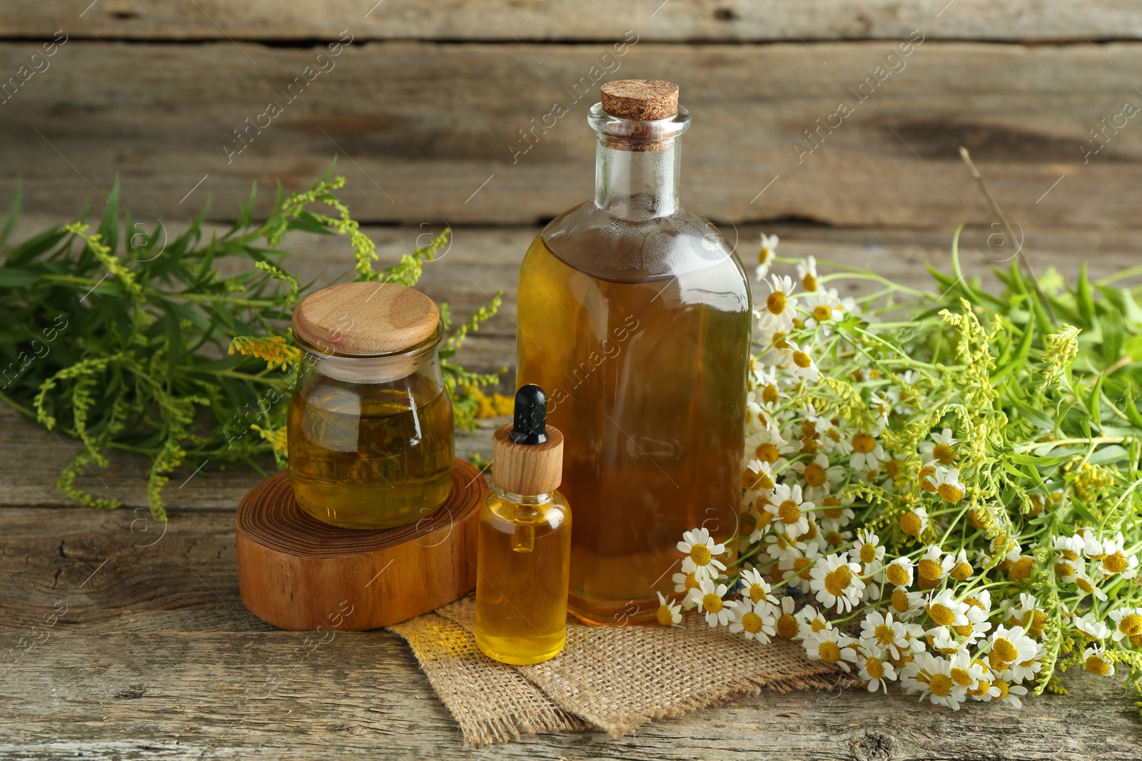 Photo of Tinctures and medicinal herbs on wooden table