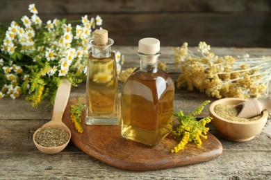 Photo of Tinctures in bottles and medicinal herbs on wooden table