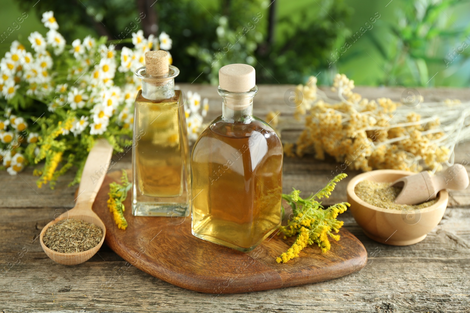 Photo of Tinctures in bottles and medicinal herbs on wooden table