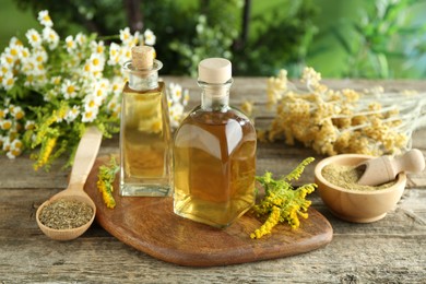 Photo of Tinctures in bottles and medicinal herbs on wooden table