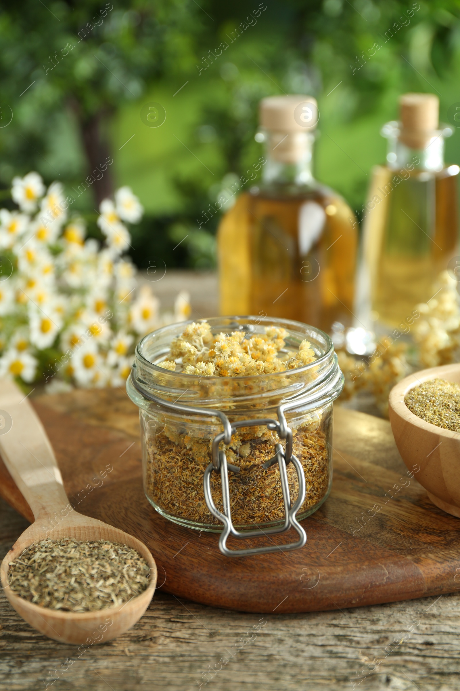 Photo of Different ingredients for tincture on wooden table