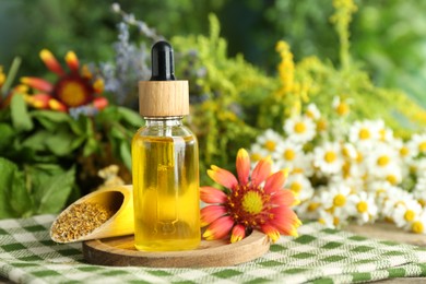 Photo of Tincture in bottle and medicinal herbs on table