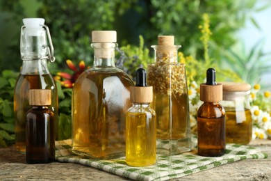 Photo of Different tinctures in bottles and medicinal herbs on wooden table