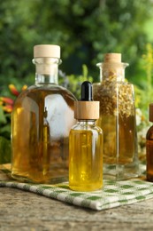 Photo of Different tinctures in bottles on wooden table