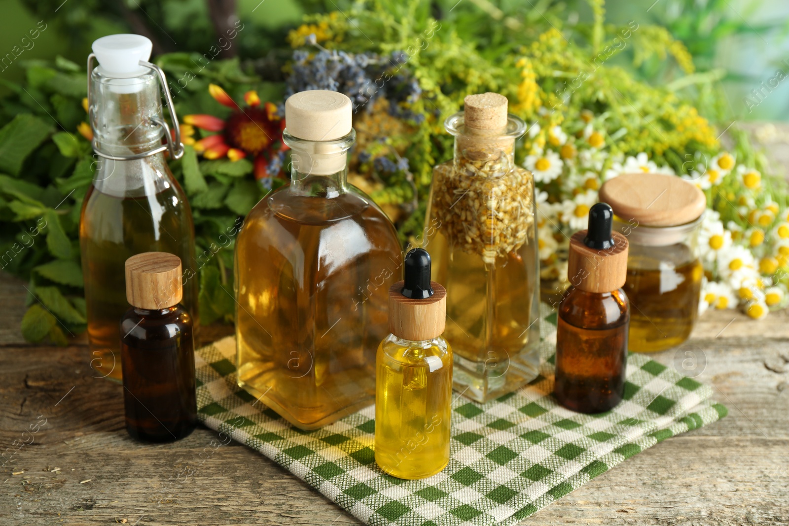 Photo of Different tinctures in bottles and medicinal herbs on wooden table