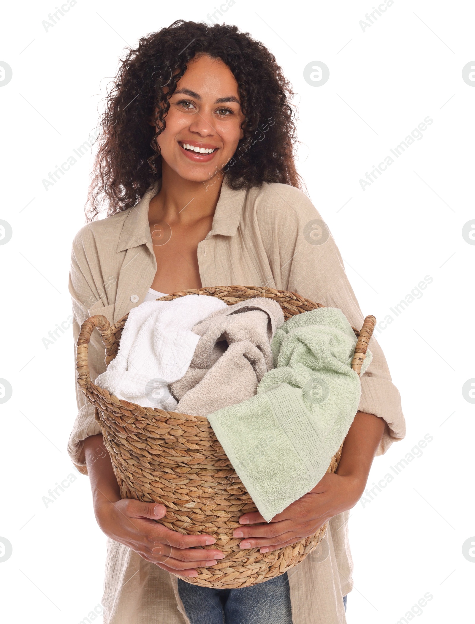 Photo of Happy woman with basket full of laundry on white background