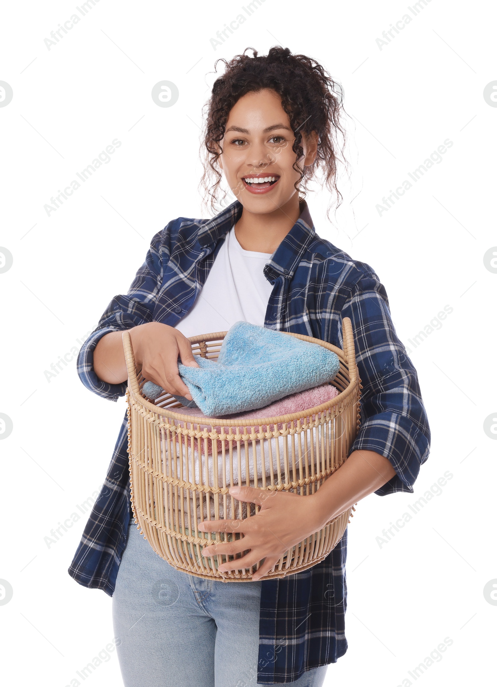 Photo of Happy woman with basket full of laundry on white background