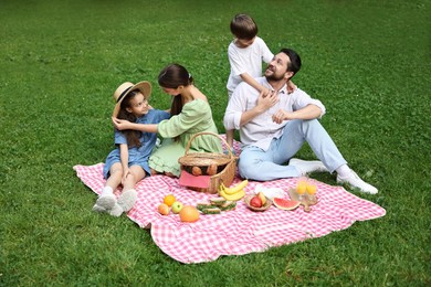 Happy family having picnic together in park