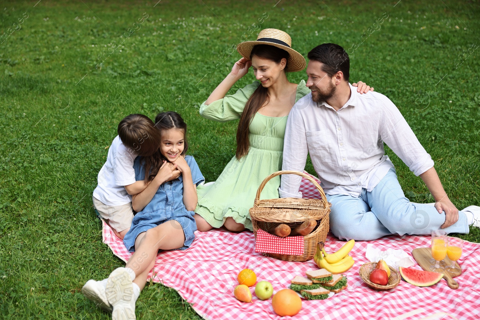 Photo of Happy family having picnic together in park