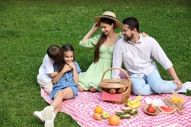 Happy family having picnic together in park