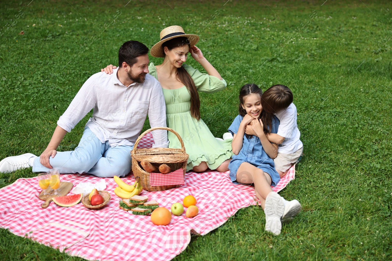 Photo of Happy family having picnic together in park