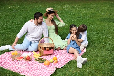 Happy family having picnic together in park