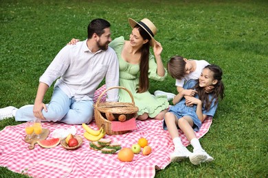 Photo of Happy family having picnic together in park