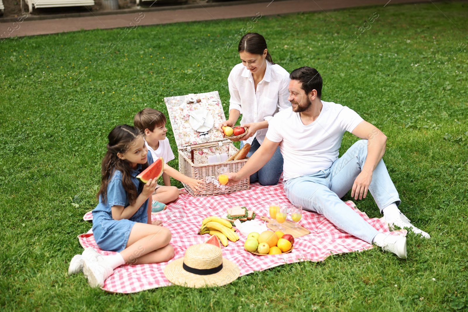 Photo of Happy family having picnic together in park