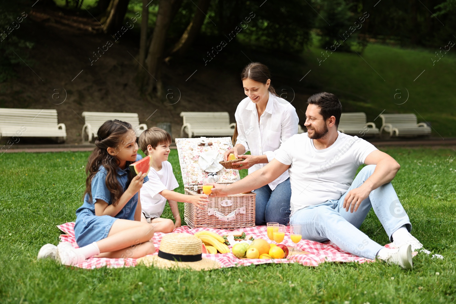 Photo of Happy family having picnic together in park