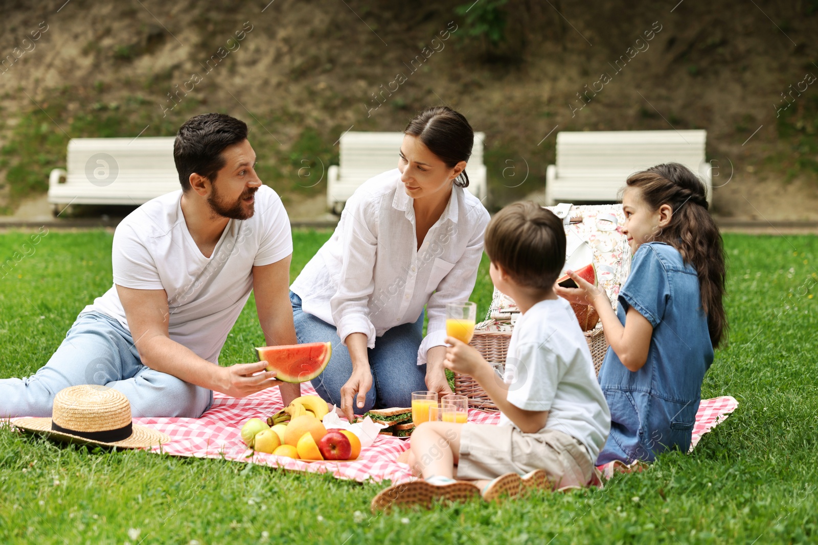 Photo of Lovely family having picnic together in park