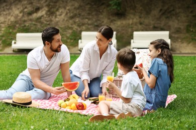 Photo of Lovely family having picnic together in park